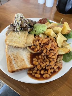 Vegan Breakfast of tofu, toast, mushrooms, beans, potato, avocado, spinach and tomato jam  at Two Birds Eatery in Hamilton