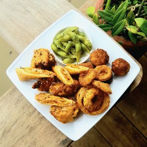 Homemade vegan munch plate including spring rolls, vegan cheese bites, onion rings and more to choose from! at The Hideaway in Kampot