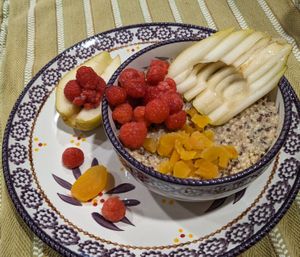 Millet and quinoa porridge with pear, raspberry, and dried apricot at Country Hearth Bed & Breakfast in New Holland