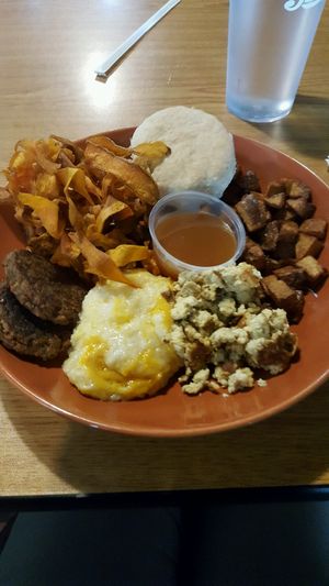 Brunch bowl!!! ? Creamy grits, fluffy biscuit, lovely fruit spread, yummy sausage, so good!!!  at Bean Vegan Cuisine in Charlotte