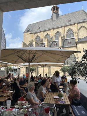 Outdoor seating with church view  at Cafe Extrablatt in Cologne