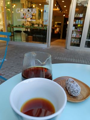 Front of store, black coffee and an energy bar at Curious Buds in Luxembourg City