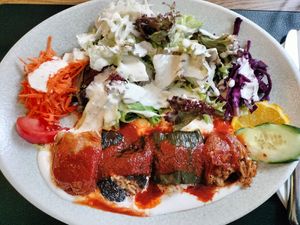 Verdure ripiene di riso speziato con salsa di pomodoro e insalata mista condita con abbondante salsa yogurt at Anatolia in Basel