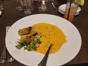 Coconut curry with tofu, strawberry rhubarb mocktail at Zeitgeist Restaurant & Bar in Duluth