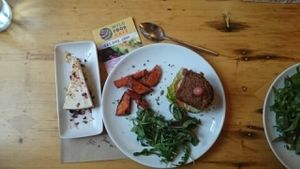 raw vegan cake and burger with sweet potatoe chips  at Wild Food Cafe in London