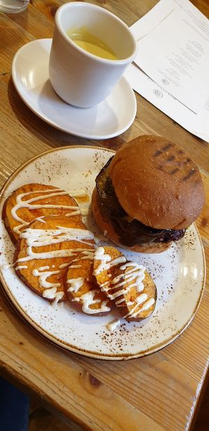 Burger, sweet potato slices and yummy hot drink at Wild Food Cafe in London