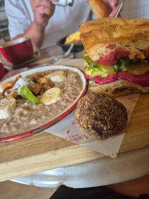 Vrunch: toast with beetroot hummus, pickles, arugula and avo (decent). Delicious porridge. Energy bal (not that great) at Adorado in Madrid