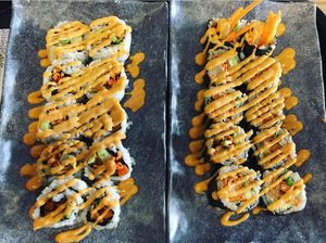 Vegan Sushi (one with white rice, one brown) both with: sweet tofu, sweet fries, carrot, avocado, green onion, pineapple, toasted coconut, and vegan dynamite sauce. @happier_meahl at Rollbotto Sushi in St Petersburg