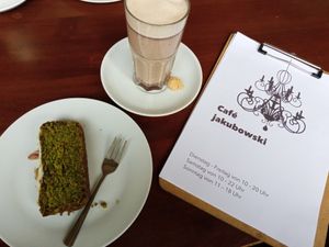 Hot chocolate (oat milk) and lemon pistachio cake at Café Jakubowski in Cologne