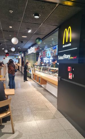 Located near the large McDonald's sign at WAW - Salad Story - Gate 32 in Warsaw