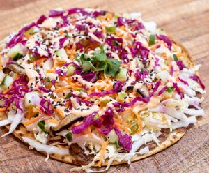 Banh Mi FLAT: Red bean & ginger spread layered on lavash bread and topped with napa cabbage, shredded carrots, shiitake mushrooms, pickled red cabbage, cucumbers, scallions,... at worldFLATS - Ridgewood in Ridgewood