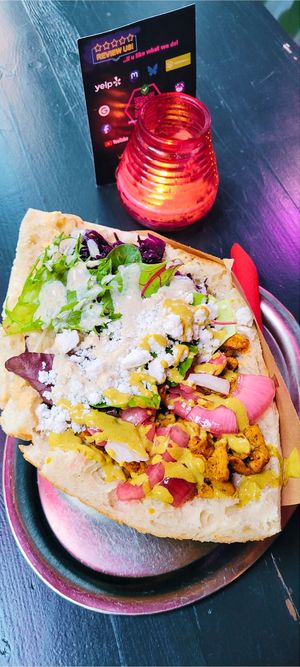 Plantpowered Döner: tschüüüsch Kevab in flatbread with LuckyFreedChicken +  Pinky Onions + MagicCurryMayo + 	
GarlicFusion + KräuterRiots + On Top Like ₣eta at tschüüüsch - plantpowered futurefood in Berlin