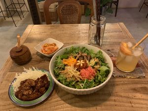 Bibimbap with vegan kimchi and soy meat sides. The drink was a seasonal fruit (peach) sparking juice. A dessert was also included with the set!  at TU CASA - Zero waste & Plant based トゥ・カサ in Kyoto