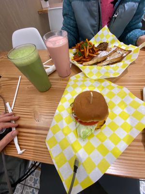 French toast with sausage and sweet potato fries, chicken sandwich, strawberry milkshake and green smoothie.  at Vegan Grill - Upper East Side in New York City