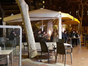 Outdoor seating in a tent at Café Bar Arco Iris in Madrid