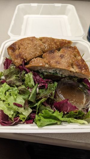 Golden beet sandwich on focaccia with a side salad! at Bake Shop in Seattle