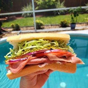 Ultimate ham & Swiss both made in house topped with lettuce, tomato and onion. Served with sub sauce and mayo/mustard. at Garden of Feeding  in West Melbourne