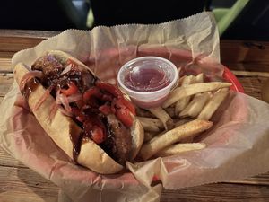 The Rick and Morty Hot Dog- Beyond sausage topped with pickled red onions, roasted red peppers, and a house made Szechuan sauce. Side of fries or chips included    at Sun-Ray Cinema in Jacksonville