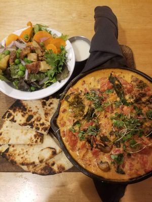 Shakshuka with tomatoes, kale, mushrooms, and onions; pita bread; side salad with lemon peppercorn vinaigrette (all vegan; dressing contains honey) at Driftless Cafe in Viroqua