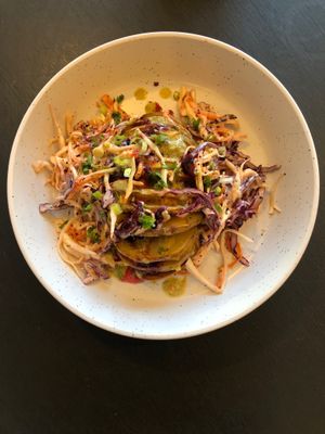 Hasselback potatoes with vegan smoked cheese, plum sauce, winter coleslaw and a caper and lemon dressing  at Dill's Cafe & Store in Falmouth