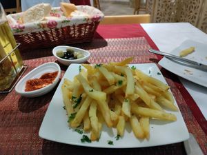 Huge serve of fries. Free olives, harissa and bread at Les Arcades in Tozeur