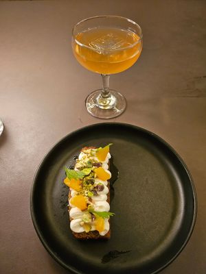 Orange cake slice topped with the creme fraiche, orange, and pistachios at Beyla in Copenhagen