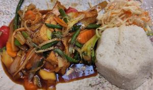Item 80: fried tofu with vegetables in chop suey sauce; served with rice and a small cabbage salad at Asia Sushi Bar in Rathenow