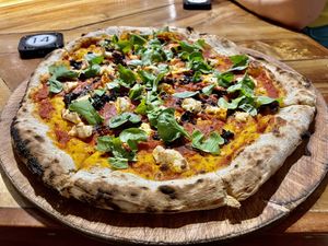 Small vegan pizza with arugula, spinach, wild mushrooms, and free basil and chili oil and vegan parmesan.  at Gorgonzola Pizza & Pasta - El Nido in El Nido