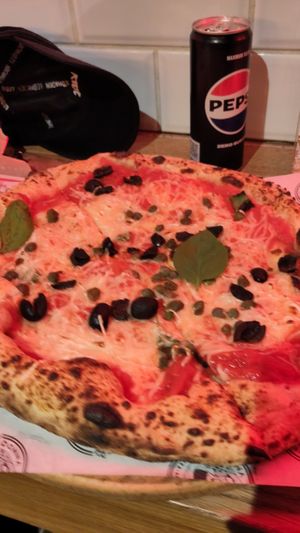 Pizza with olives and capers at Donna Mamma in Budapest