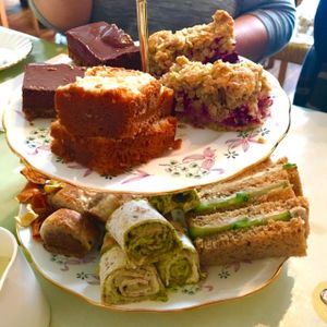 Selection of cake, sandwiches, wrap, 'sausage' rolls and vegetable crisps  at Flying Goose Cafe in Nottingham