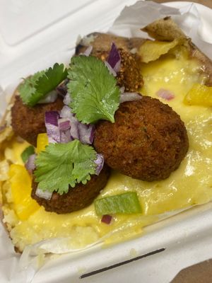 Baked potato with vegan cheese and falafel vegan  at Spud & Shakes in Glasgow
