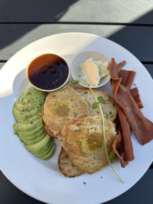 Vegan fried eggs with avocado and vegan bacon.   at Harrow and Harvest Cafe in Lilydale