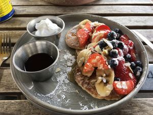 Pancakes with berries, orange syrup and vegan whipped cream  at HOB in South West London