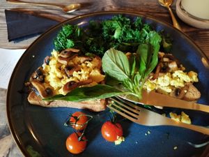 Beautiful, full moon breakfast, gluten free toast, you can have glutenous Bread if you want, but mine is gf ... with houmus, scrambled tofu, wilted kale, garlic mushrooms, roasted  at Moon Coffee House in Scunthorpe