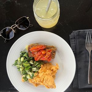 Mashed battata and pink yams with a cashew sour cream , lentil meatloaf with roasted tomatoes and sautéed greens  at Bushbungalow  in All Saints