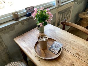 Hazelnut oat milk latte with a free photo card at Ksana 크샤나 in Busan