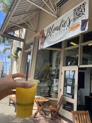 Outside (featuring my pineapple juice!)  at Blondies Vegan Proteins + Cafe Hawaii in Honolulu