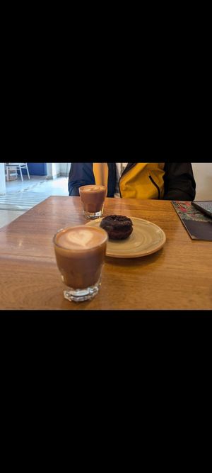 Almond milk and lovely coffee with vegan chocolate donut at Colo Coffee Andes in Bogota