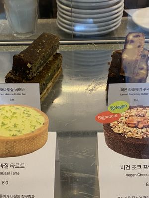 Sign for a vegan cake on the right (they were out of this one, but I appreciate the clear labelling)  at mtl cafe & bakery in Seoul