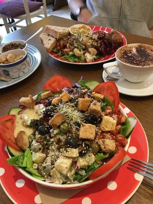 Best vegan food in town! Nearest is the large salad and furthest is the falafel one. Leaves, beans, pickles, olives , seeds (optional) potato salad , coleslaw. They vary it too!  at Toucan Cafe in Minehead