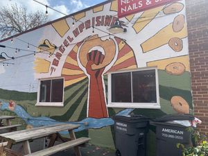 Mural by outdoor seating at Bagel Uprising in Alexandria