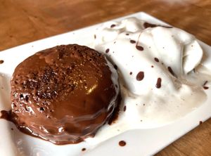 Rich chocolate cake served with a scoop of Coconut Milk Ice Cream at Veg Head in Lansing