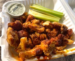 CAULIFLOWER WINGS

Hand-battered Cauliflower served with side of BBQ sauce, House Ranch or Nashville hot sauce and Celery sticks at Veg Head in Lansing
