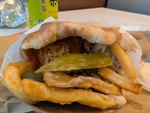 Pickle and a couple of fries adorn the falafel at Moshe's Falafel in New York City