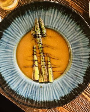 Paprika soup with balsamic cream and asparagus  at Garzon Café  in Budapest