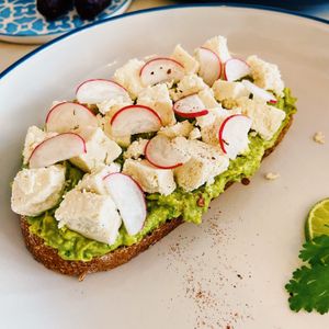 Avocado toast with vegan feta   at Unicorn Noms in Janabiyah