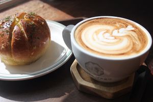 Garlic cream cheese bun and latte  at Cafe Vegu in Lewes