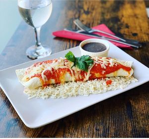 Enchiladas -squash and sweet potato filled enchiladas topped with our homemade enchilada sauce with authentic Mexican flavours & handful of vegan cheese  at The Burrito - Comida Mexicana in Southend-on-sea