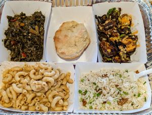 Platter of sides: collard greens, biscuit, Brussels sprouts, mac & cheese, and soul rice 🤤 at Vegan Soul in Boise