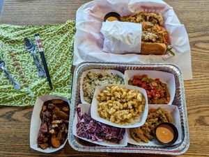 Mac 'n' cheese, fried cactus, cabbage slaw, stewed okra and tomato, Soul Rice, peach cobbler, po' boy sandwich with fried cactus at Vegan Soul in Boise